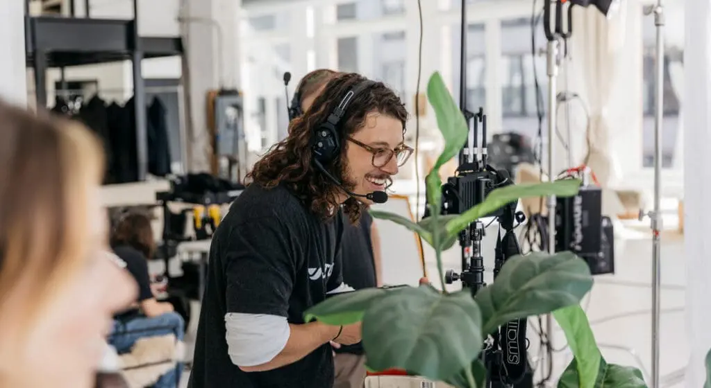 man smiling behind camera