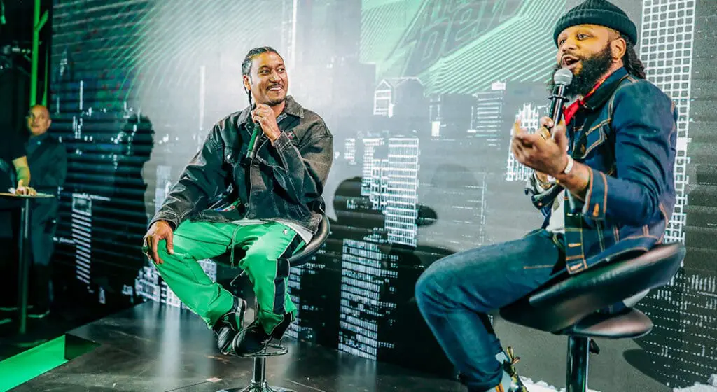 one man interviews another on stage