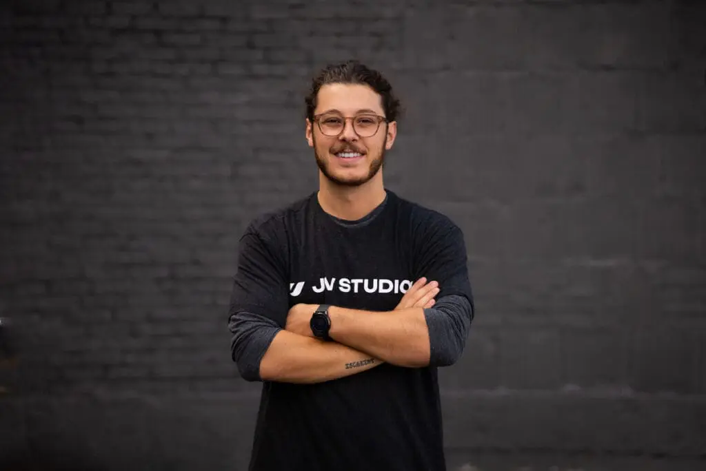 Creative director wearing jv studios tshirt with arm crossed