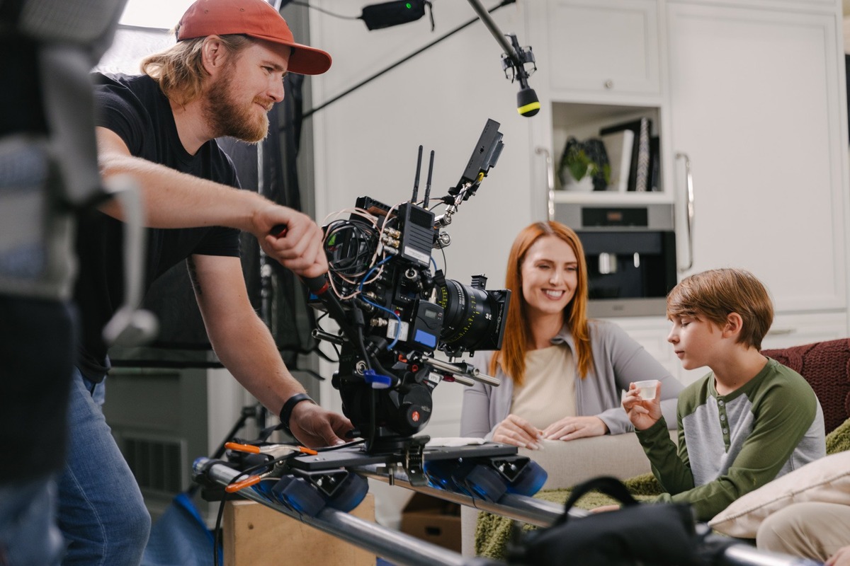 man taking a video of mother and son