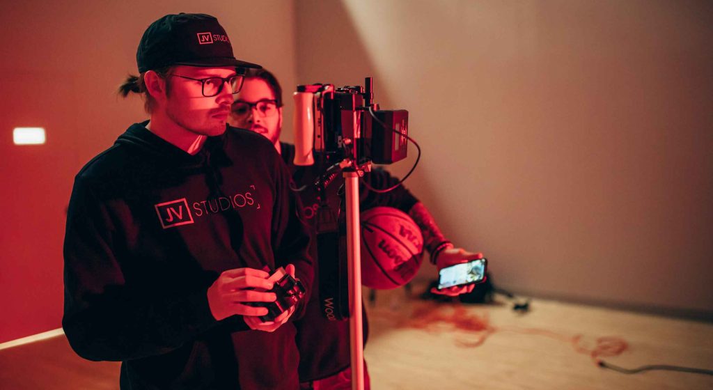 man in red light looking at a camera