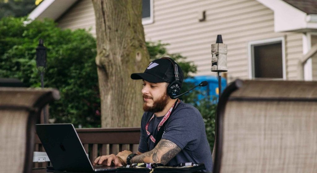 man working at a computer on a commercial set